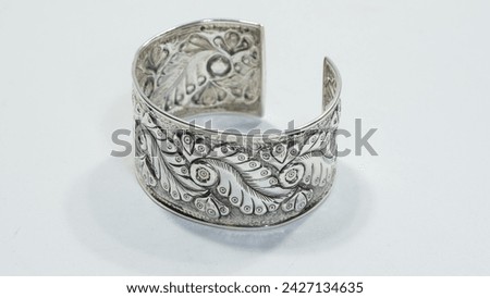 Handmade silver bangle on white background