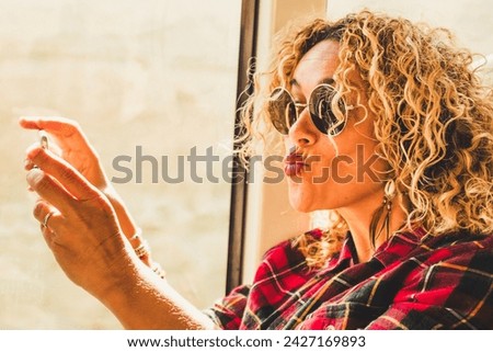 Funny happy beautiful caucasian woman doing selfie and expression with mobile phone - couple traveling together  in bus or train and enjoying technology and modern devices