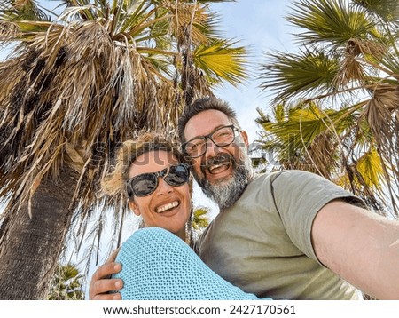 Happy middle aged couple have fun walking outdoors in the city. Couple enjoying a tourist walk on the street in spring. Tourist couple relationships and newlyweds' holidays. Royalty-Free Stock Photo #2427170561