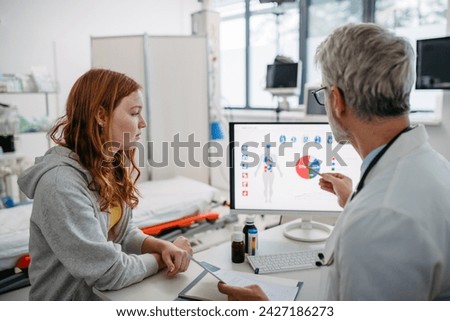 Teenage girl explaining her health problems, pain. Doctor showting medical test results. Concept of preventive health care for adolescents.