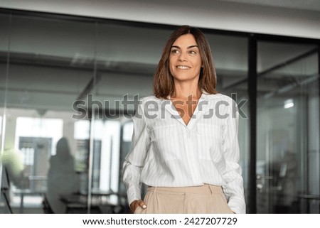 Gorgeous successful hispanic senior business woman standing confident proudly smiling aside. European Latin 40s years mature good looking middle age leader female businesswoman in office, copy space. Royalty-Free Stock Photo #2427207729