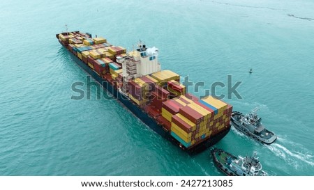 tug boat are pulling Cargo container ship to customs port import export goods to cargo yard port to customs. concept logistics transportation and shipping.	

