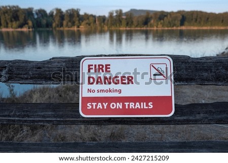 Forest fire warning sign board. Extreme Fire Danger Sign in the park. Sign forbidding bonfires. Danger of forest fires. Burning grass. A red sign It is forbidden to light a fire.