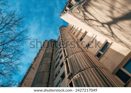 Low angle view of tall residential skyscraper building built in brutalist architectural style in 1980s in former Yugoslavia, selective focus Royalty-Free Stock Photo #2427217049