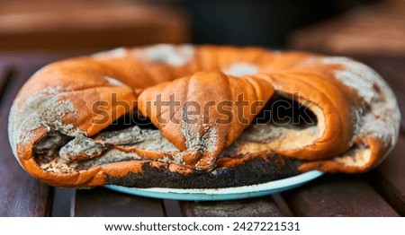 Sorrowful or sad face on rotten, flattened pumpkin. Sour look full of sorrow and sadness. Delusion on a spoilt pumpkin wicked face. Halloween unhappiness on a rancid pumpkin. Halloween censure concept Royalty-Free Stock Photo #2427221531
