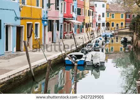 Murano and Burano island landscape. Venice region in Italy. Colorful carious home facades. Water in canal. Parked boats. Royalty-Free Stock Photo #2427229501