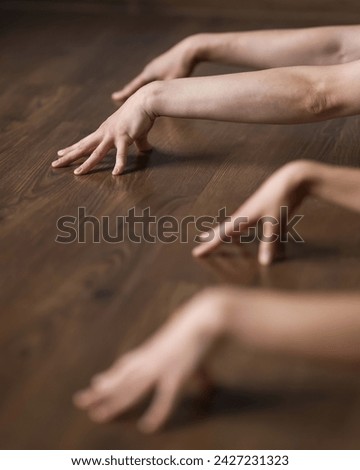 Bent Hands with spread fingers. Yoga asana element. Lifting onto fingers. Strong, flexible fingers. Hand warm-up.Wooden background. Soft focus. Side view.