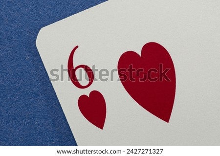 The Six of Hearts on a blue background Royalty-Free Stock Photo #2427271327
