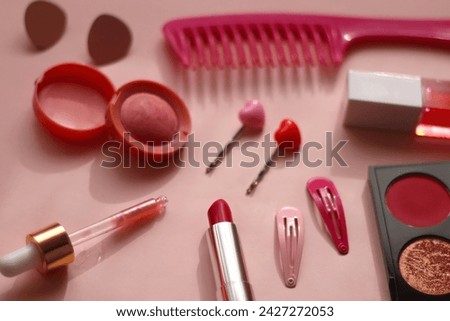 Various pink accessories and make up products on bright pink background. Selective focus.