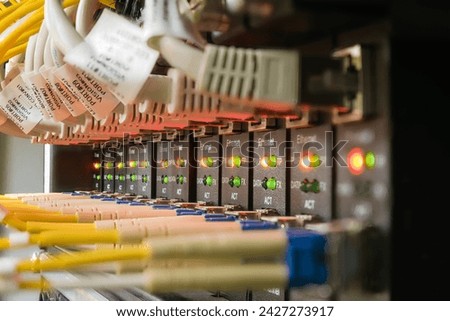 Network connection device with network switch, Ethernet router, Ethernet cables, fiber optic cables and status LEDs Royalty-Free Stock Photo #2427273917