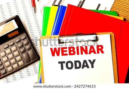 WEBINAR TODAY text written on a paper clipboard with chart and calculator Royalty-Free Stock Photo #2427274615
