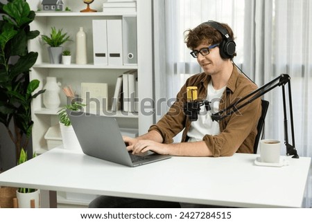 Host channel of influencer searching information for answering to listeners on social media with laptop in life coaching. Concept of radio online lifestyles at cozy studio modern home office. Gusher.