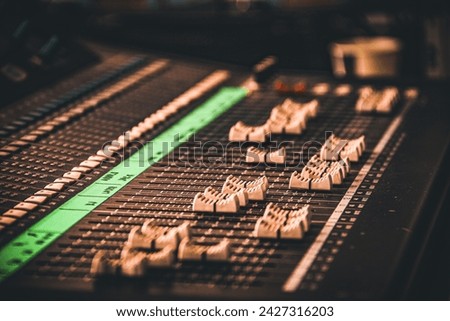 DJ mixing desk with knobs in a focus view on the deck of the audio master instrument with closeup view.