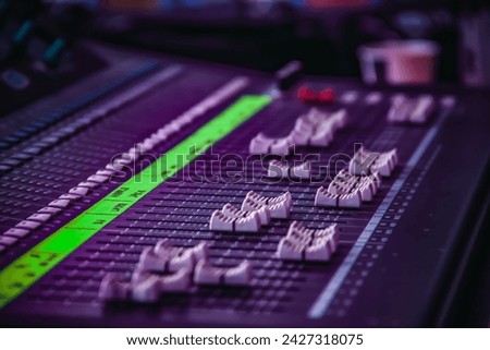 DJ mixing desk with knobs in a focus view on the deck of the audio master instrument with a closeup view.