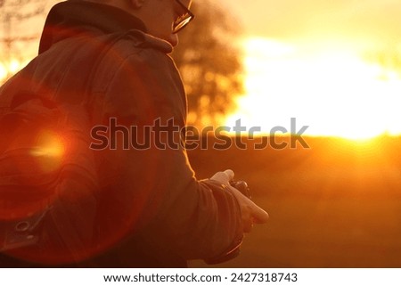 Soft focus of man photographer hold camera on sunny nature background. Copy space. Banner for design.