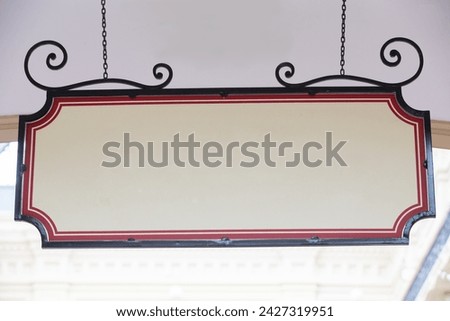 Blank curly rectangular banner sign hanging on chain blank template.