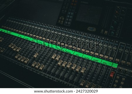 DJ mixing desk with knobs in a focus view on the deck of the audio master instrument with a closeup view.