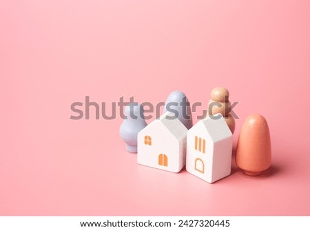 Figures of houses and trees on a pink background. Buy or rent a home. A pink dream in your own home. Mortgage and loan. Affordable housing. Buying a nice house.