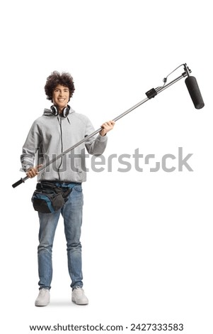 Boom operator with headphones and microphone smiling at camera isolated on white background