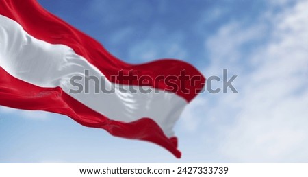 The national flag of Austria waving on a clear day. Three equal horizontal bands: white, red upper  lower, middle band. 3d illustration render. Selective focus. Rippled fabric.