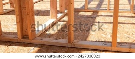 Panorama OSB sub flooring sheets cover, attach to the joists with wood screws Oriented Strand Board plywood, timber framing posts beams studs, new house construction, interior wall framing, Texas. USA Royalty-Free Stock Photo #2427338023