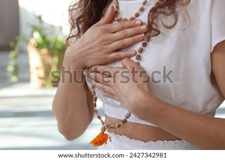 Yoga Woman Meditating, holding hands on the heart close up. Loving Kindness Meditation, Self-love , Gratitude concept Royalty-Free Stock Photo #2427342981
