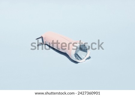 photo of a pink flashlight on a white background.