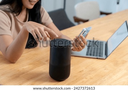 female with portable speaker at home
