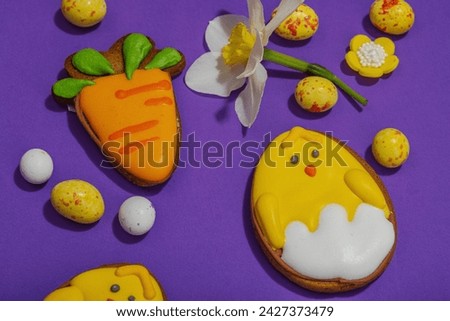 Traditional Happy Easter cookies, festive edible decor. Homemade baking concept, cute sweets. Greeting card, purple background, flat lay, close up