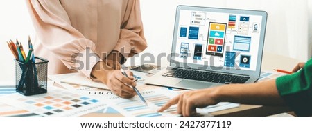 Cropped image of interior designer team recommends color by using color palette while laptop displayed UI and UX designs for mobiles app and website. Creative design and business concept. Variegated.