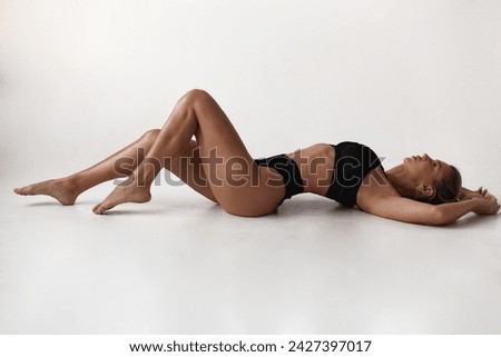 Healthy eating, sports for weight loss. Happy young blonde woman showing a perfect slim body on a white studio background, collage with outlines of an aesthetic figure