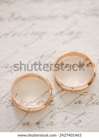 The wedding ring sits atop the letter, symbolizing the intertwining of life's joys and challenges, love's enduring commitment, and the profound journey shared by two souls, united in marriage.