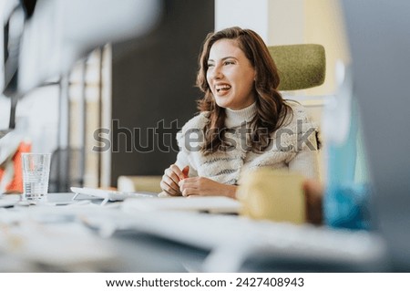 Female business employee strategizing in a cozy workplace with her teammates. Analyzing statistics for profit and market growth. People working in pleasant atmosphere. Royalty-Free Stock Photo #2427408943