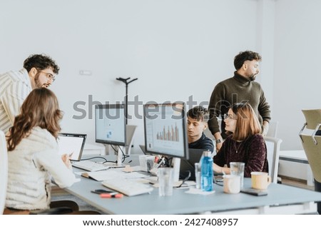 Creative business people collaborating in a cozy workplace. Royalty-Free Stock Photo #2427408957