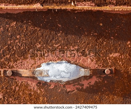 A zinc sacrificial anode on a marine vessel. The anode will dissolve protecting the iron from corrosion.