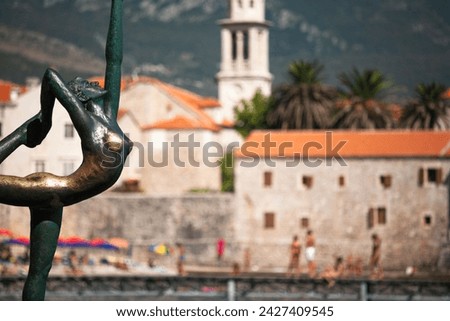 View of Old Town Budva with city beach and vacationers, Montenegro. Adriatic resort city-pearl for publication, poster, calendar, post, screensaver, wallpaper, cover, website. High quality photography