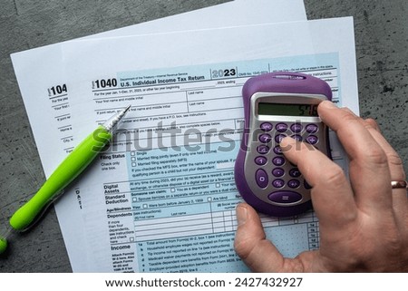 male fills in 1040 tax form 2023. Individual Income Tax Return. Finance and accounting business background