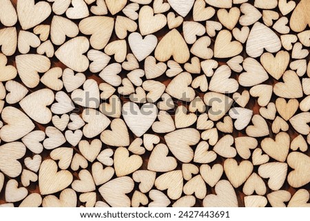 Wooden hearts textured background, full frame shot, Valentines day decor Royalty-Free Stock Photo #2427443691