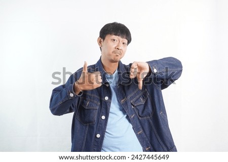 Young man hand showing thumbs up and thumbs down