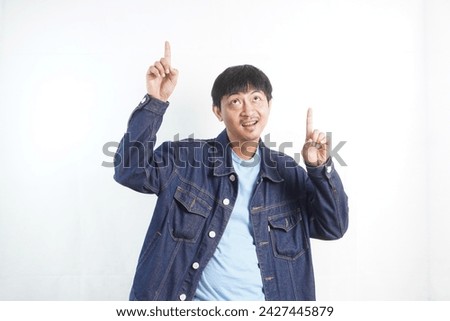 Portrait of happy Asian man showing empty space on white background. Copy space.