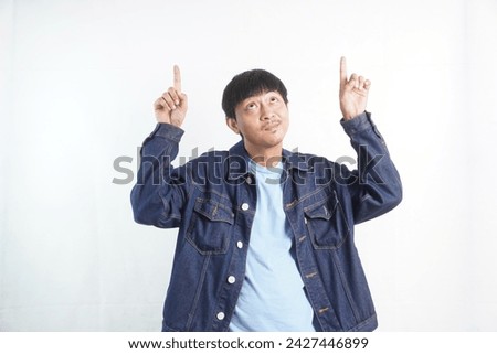 Portrait of happy Asian man showing empty space on white background