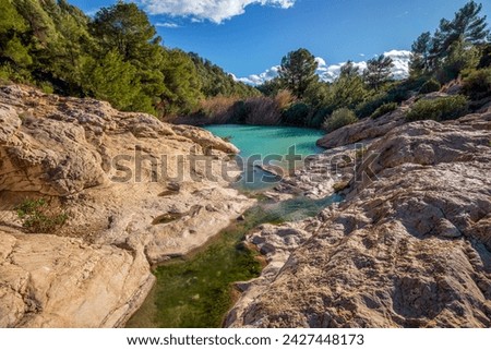 Horizontal photo of the source of Fuente Caputa, between rocks, in the town of Mula, Region of Murcia, Spain, between rocks and on a sunny day