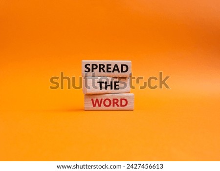 Spread the Word symbol. Concept words Spread the Word on wooden blocks. Beautiful orange background. Business and Spread the Word concept. Copy space.