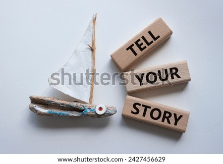 Tell your story symbol. Wooden blocks with words Tell your story. Beautiful white background with boat. Business and Tell your story concept. Copy space.