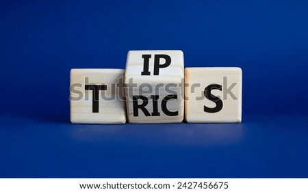 Tips and Tricks symbol. Wooden cubes with words Tricks and Tips. Beautiful deep blue background. Business and Tips and Tricks concept. Copy space