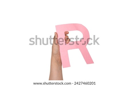 closeup hand holding paper letter R  isolated on white