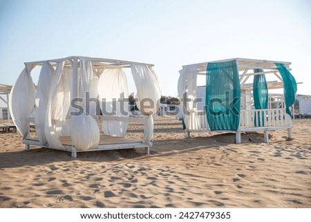 Vacation holidays background wallpaper - beach long chairs under tent on beach. Summer time. Poster, banner with copy space 
