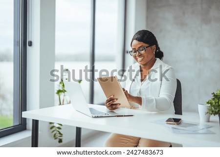 Business, black woman and tablet in office, focus and digital planning for growth, startup and sales. Corporate, African American female employee and manager with device, idea and website launch