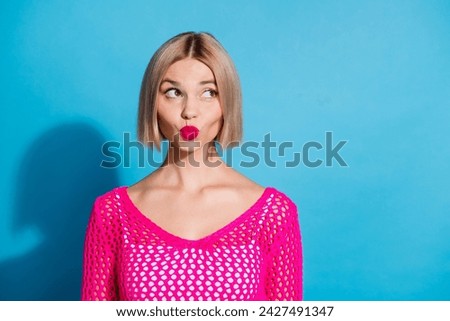 Photo of dreamy gorgeous coquettish girl dressed stylish clothes looking up empty space isolated on blue color background