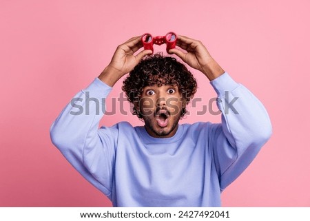 Photo of shocked impressed man wear blue stylish clothes open mouth hold binoculars isolated on pink color background